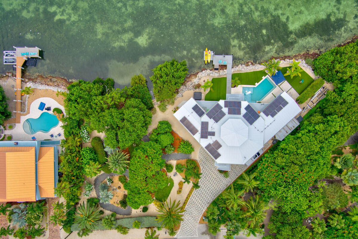 108 Sunset Drive Marathon, FL 33050 - Photo 3 of 46 an aerial view of a house with a yard and garden