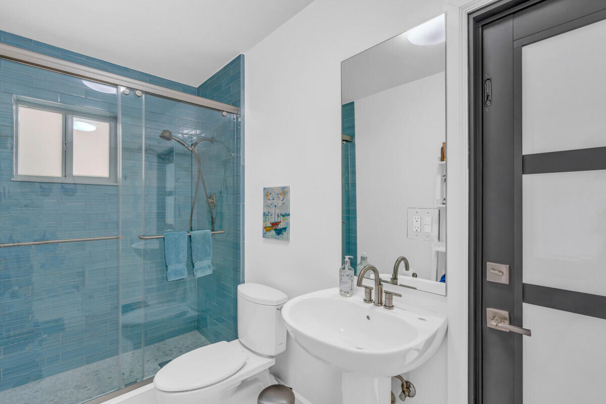 108 Sunset Drive Marathon, FL 33050 - Photo 33 of 46 a bathroom with a sink mirror toilet and shower