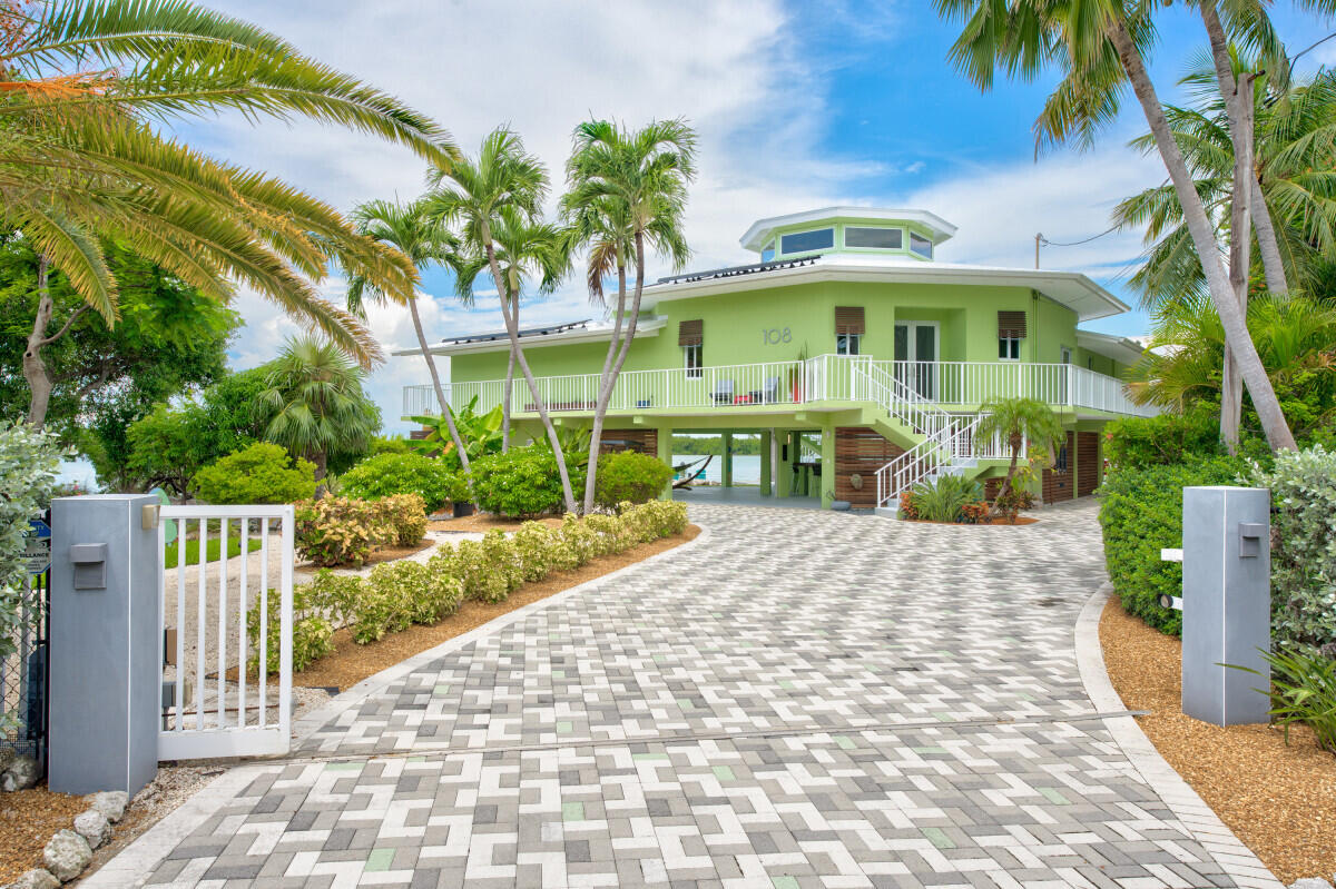 108 Sunset Drive Marathon, FL 33050 - Photo 5 of 46 a front view of a house with a yard