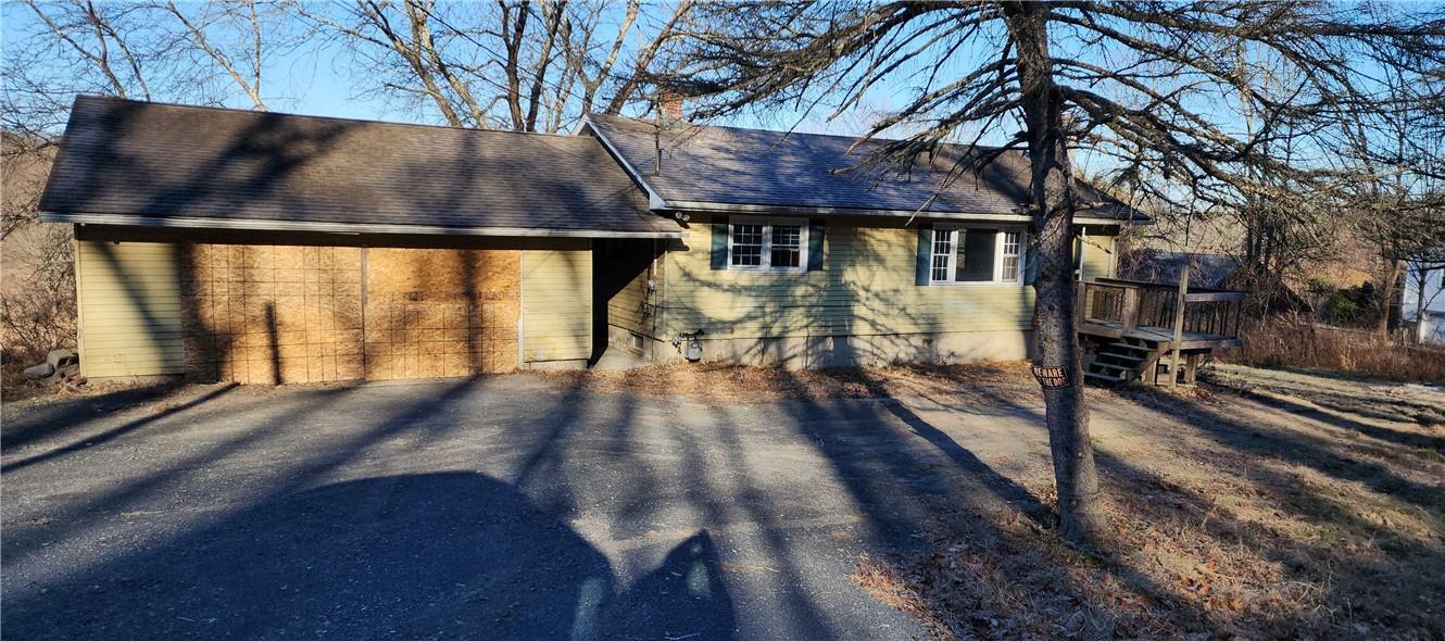 a view of house with wooden floor and outdoor seating