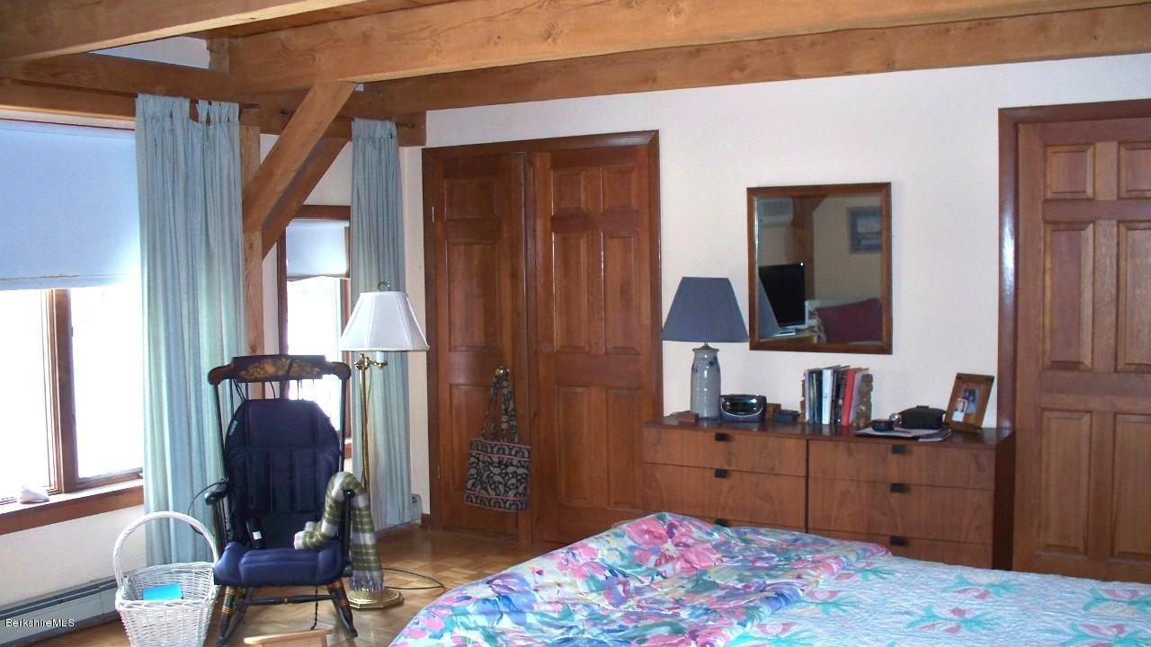 585 Shaw Road Windsor, MA 01270 - Photo 22 of 30 a bedroom with a bed and large windows