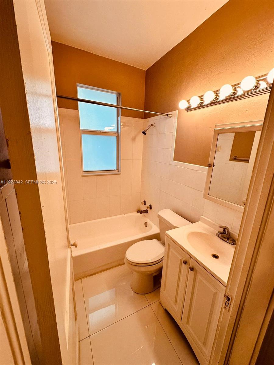 344 Mendoza Avenue, Unit 7 Miami, FL 33134 - Photo 3 of 9 a bathroom with a sink a toilet and shower