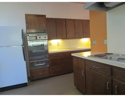 9 Stonehedge Road Lincoln, MA 01773 - Photo 4 of 14 a kitchen with a refrigerator and a stove