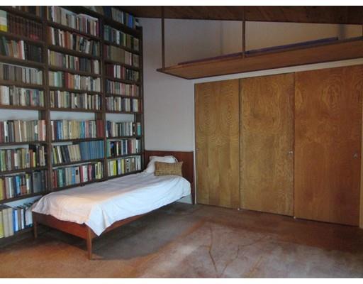 9 Stonehedge Road Lincoln, MA 01773 - Photo 6 of 14 a bed sitting in a bedroom next to a book shelf