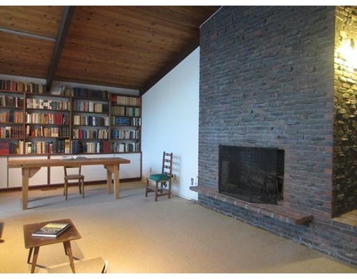 9 Stonehedge Road Lincoln, MA 01773 - Photo 9 of 14 a living room with furniture a fireplace and a dining table
