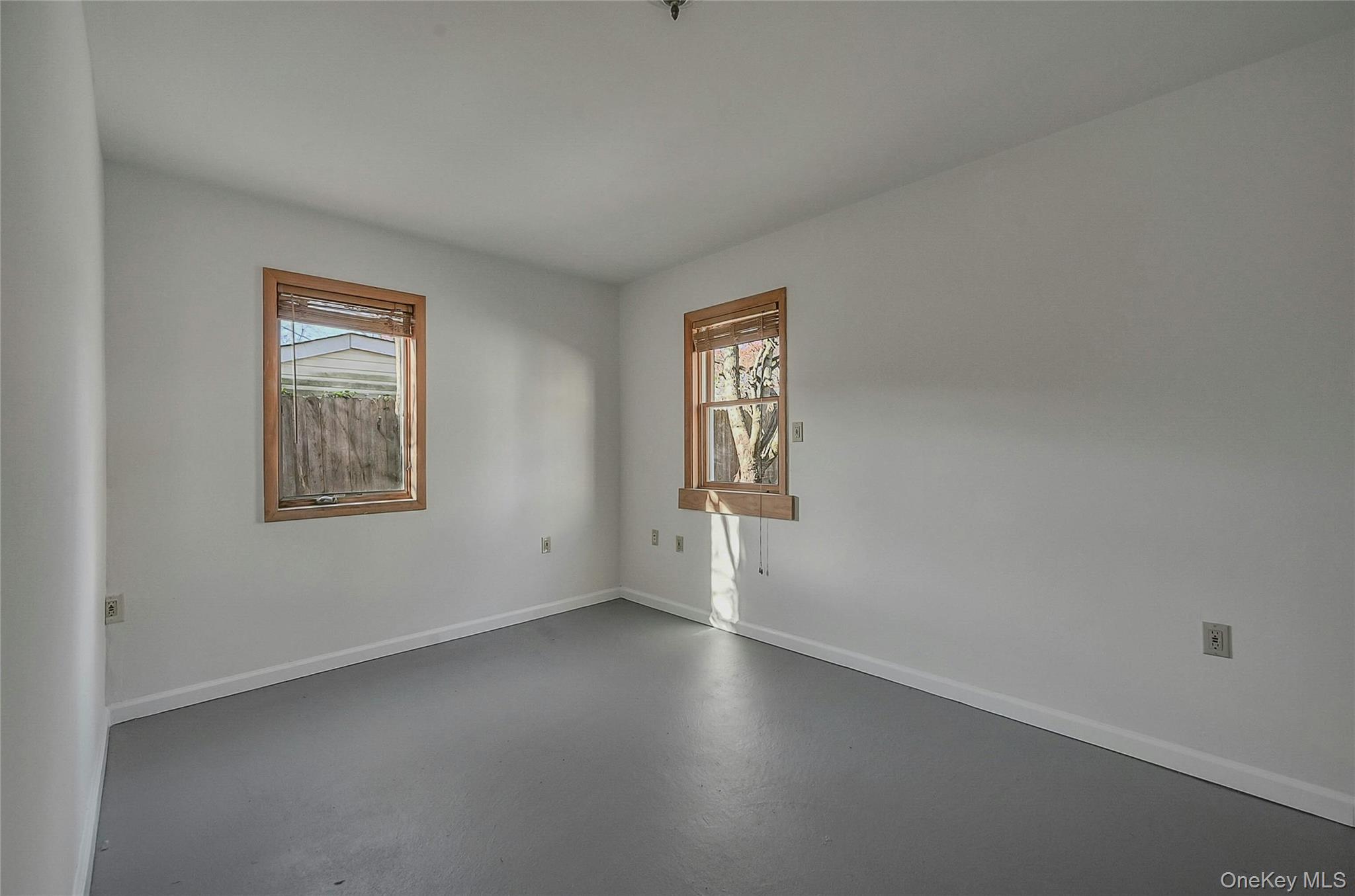 8 Pansy Road Rocky Point, NY 11778 - Photo 27 of 31 Spare room featuring concrete floors all freshly painted in addition to windows making this a bright work room in your garage