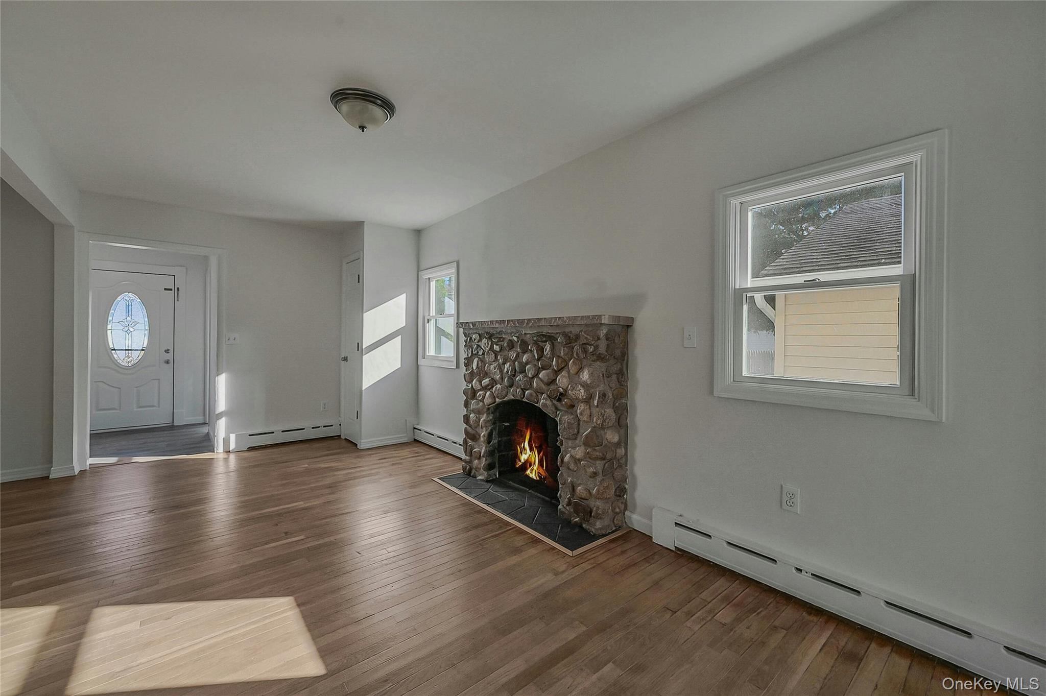 8 Pansy Road Rocky Point, NY 11778 - Photo 7 of 31 Cozy Stone Fireplace Adds Beautiful Charm To This Renovated Cape Style Home