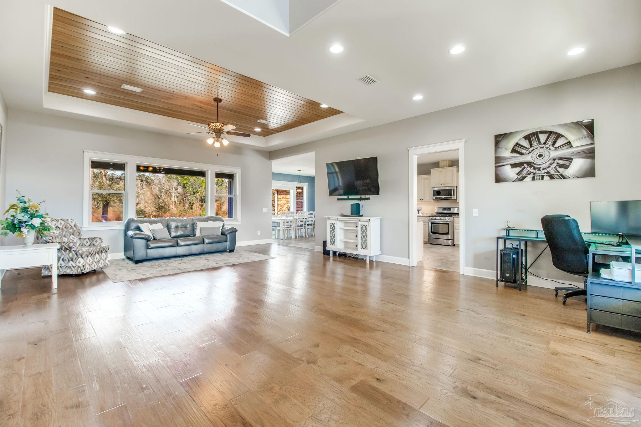 4940 Palmer Ridge Drive Milton, FL 32570 - Photo 11 of 53 a living room with furniture and a flat screen tv