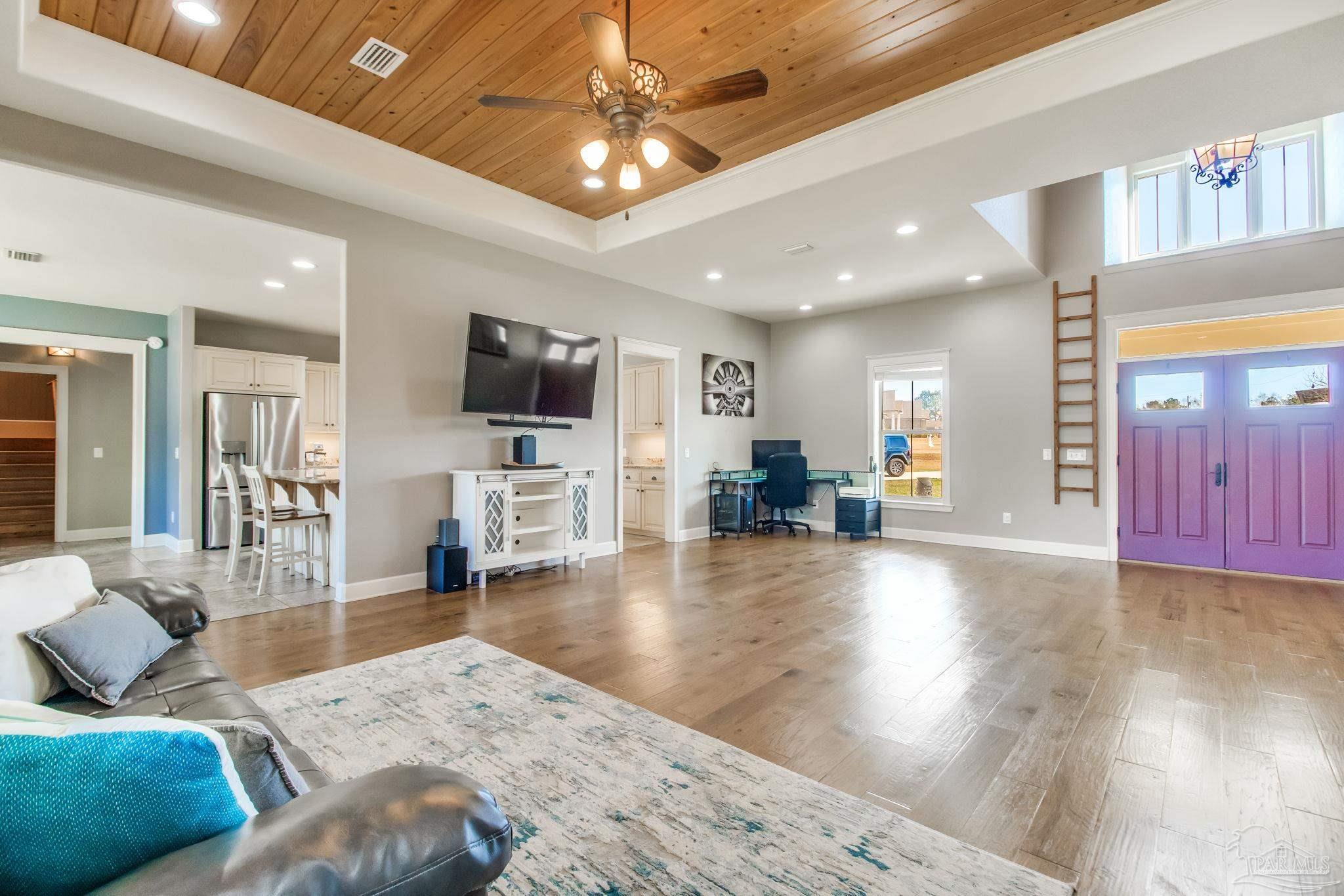 4940 Palmer Ridge Drive Milton, FL 32570 - Photo 12 of 53 a living room with furniture and a flat screen tv
