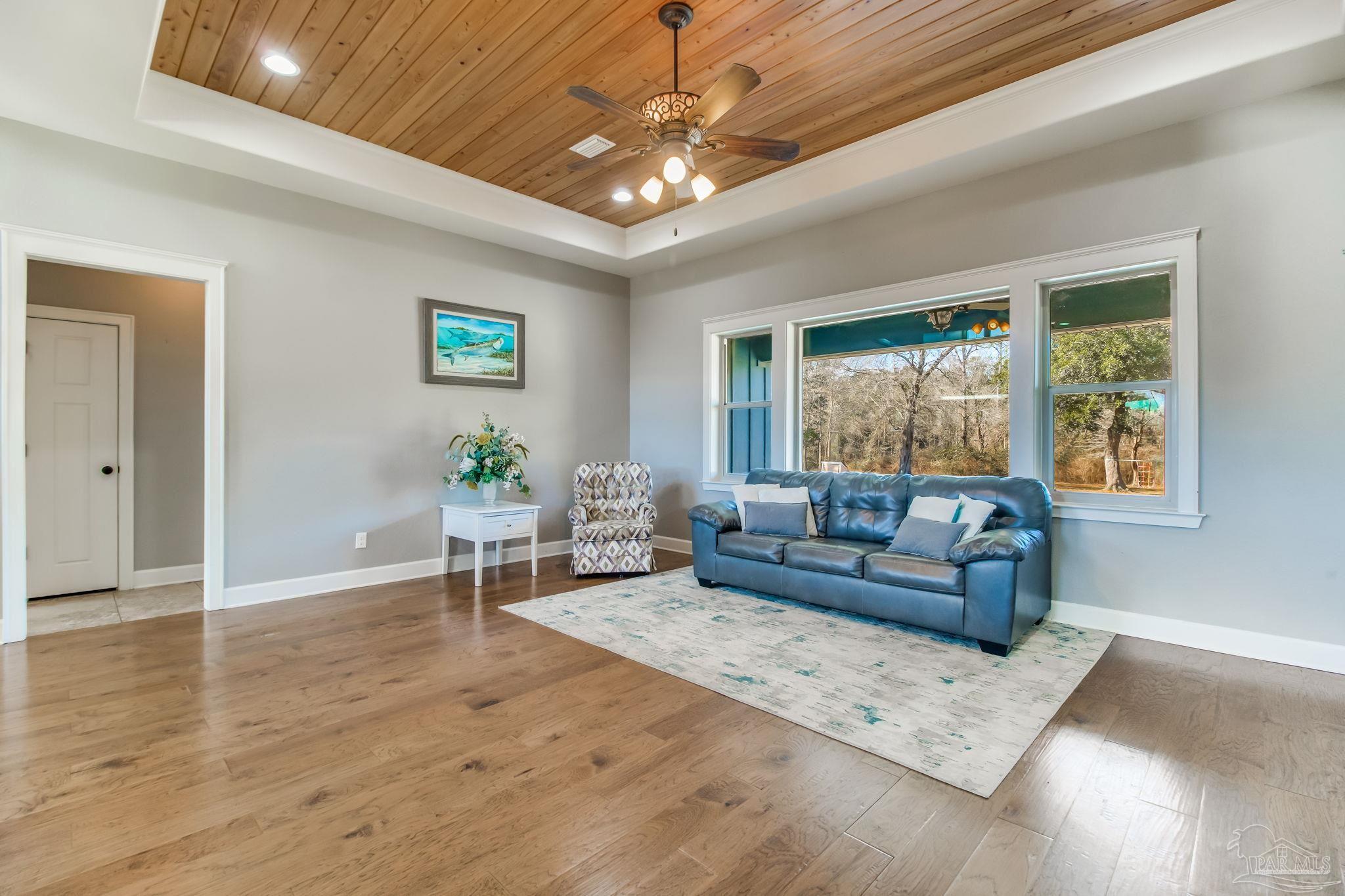 4940 Palmer Ridge Drive Milton, FL 32570 - Photo 13 of 53 a living room with furniture and a large window