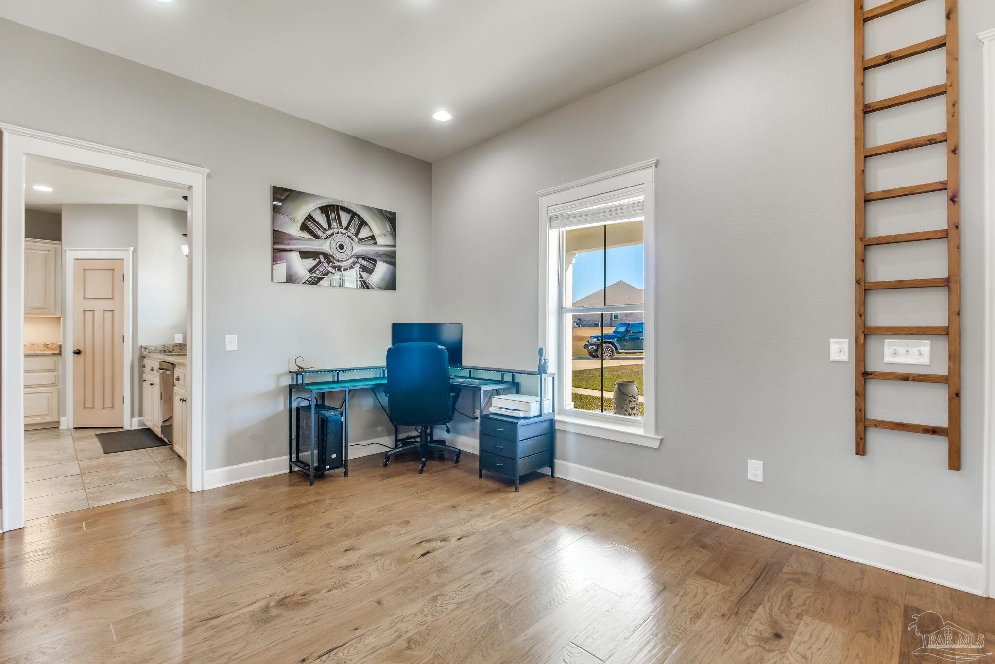 4940 Palmer Ridge Drive Milton, FL 32570 - Photo 14 of 53 a view of a workspace with furniture and a window