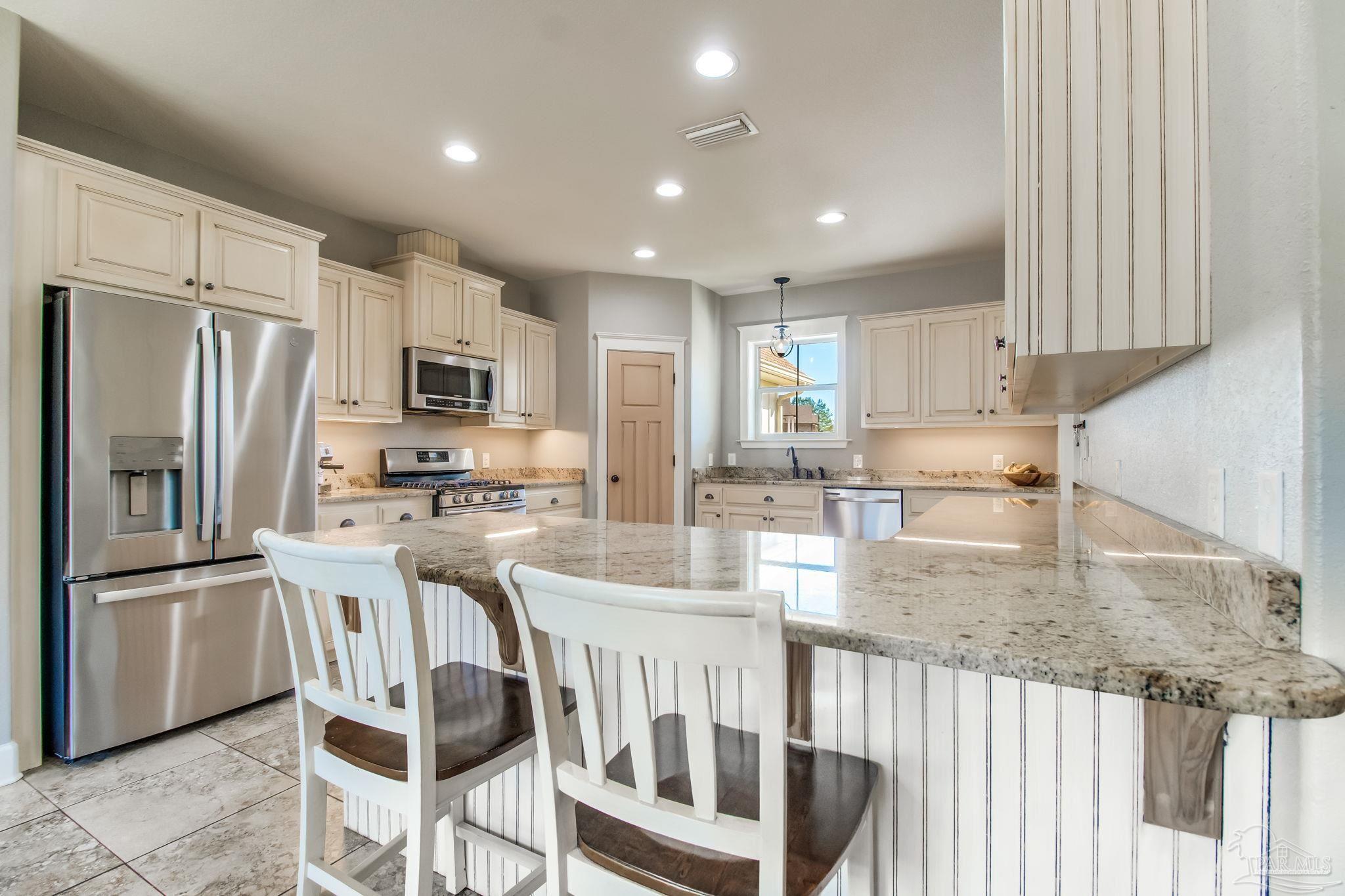 4940 Palmer Ridge Drive Milton, FL 32570 - Photo 15 of 53 a kitchen with counter top space cabinets and stainless steel appliances