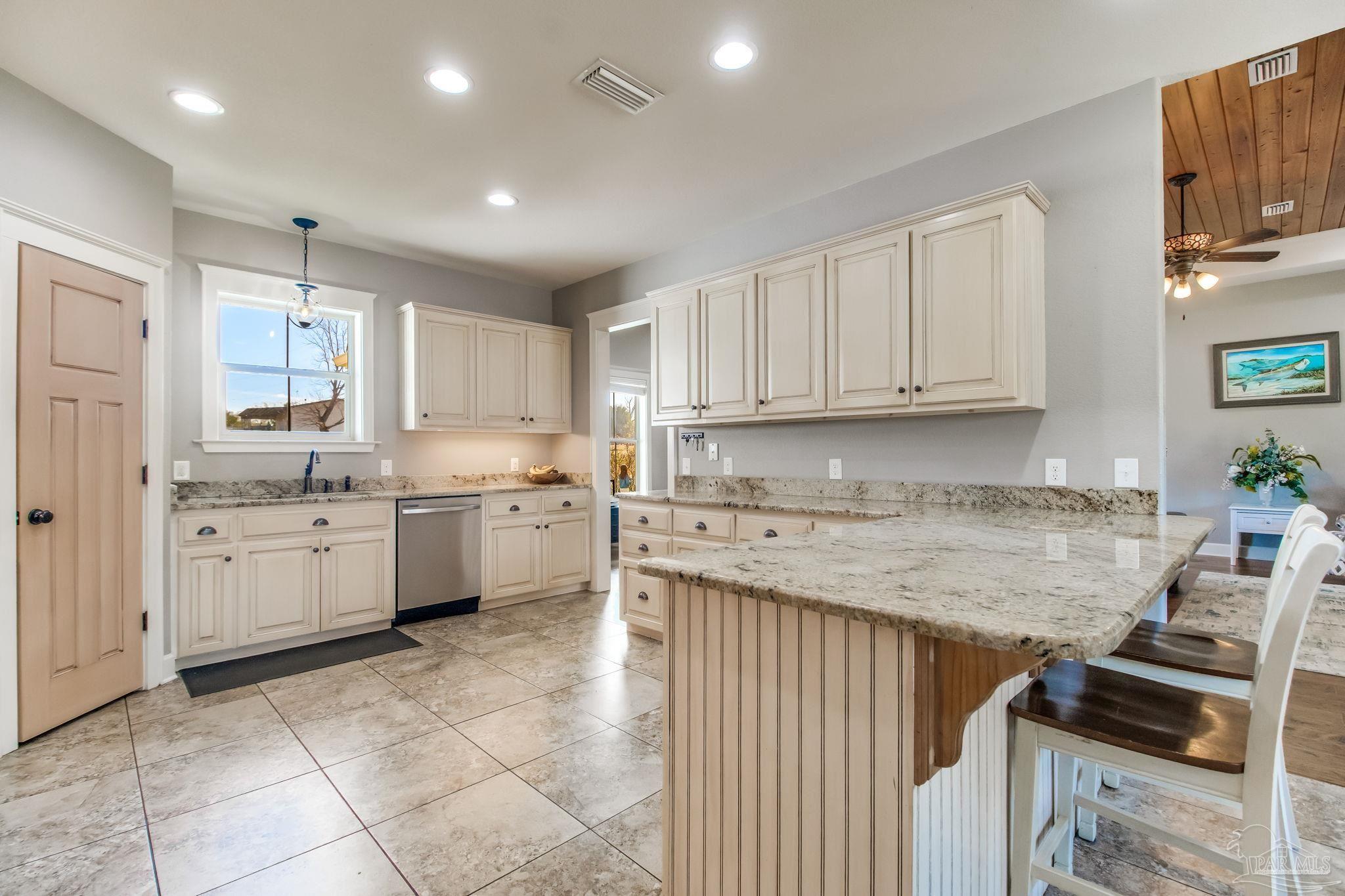 4940 Palmer Ridge Drive Milton, FL 32570 - Photo 17 of 53 a kitchen that has a sink and a stove in it