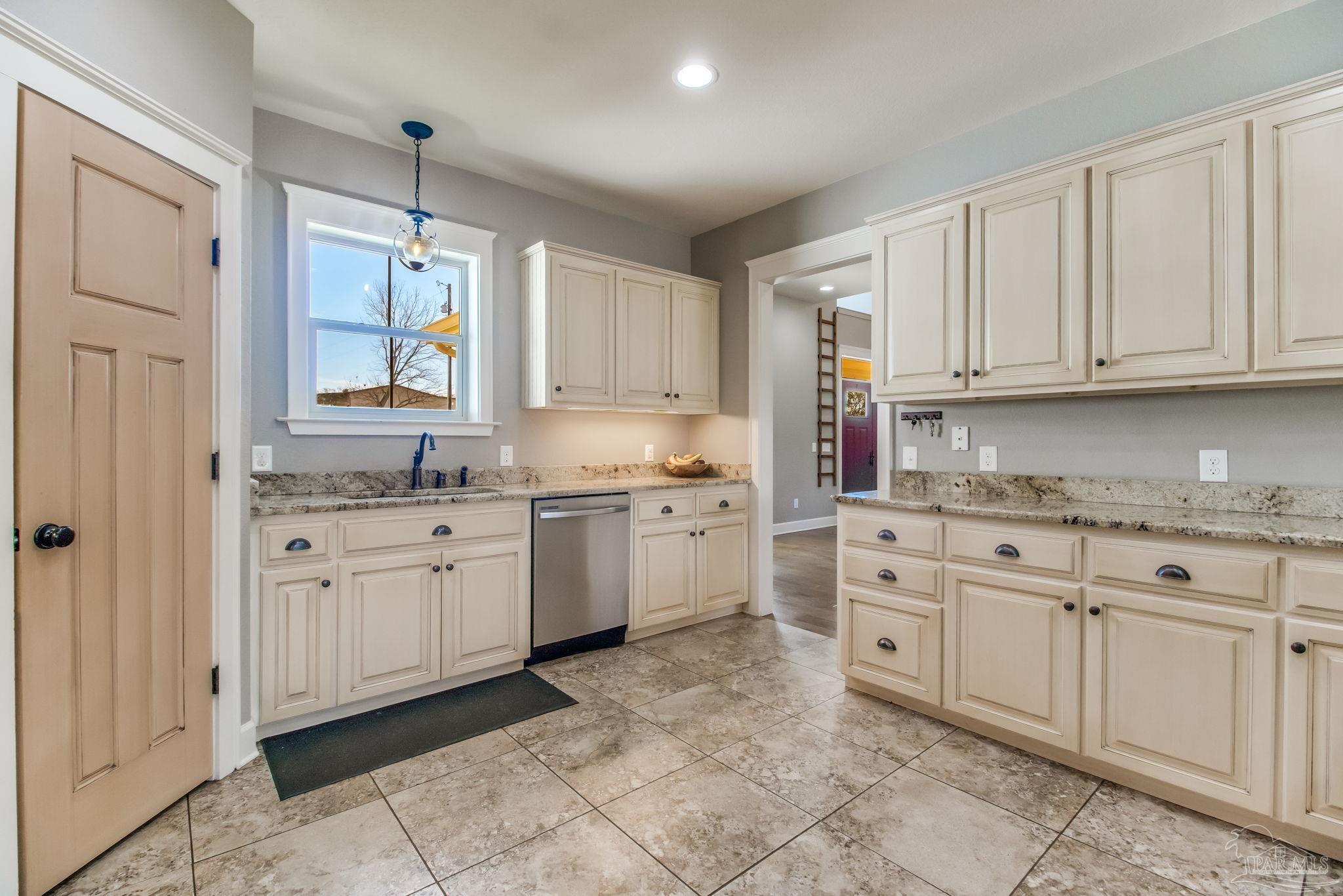 4940 Palmer Ridge Drive Milton, FL 32570 - Photo 19 of 53 a kitchen with cabinets appliances and a window