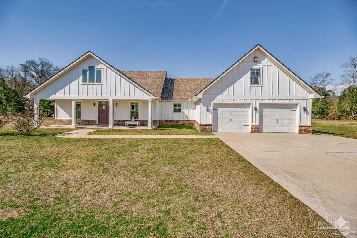 4940 Palmer Ridge Drive Milton, FL 32570 - Photo 2 of 53 a front view of a house with a yard and trees