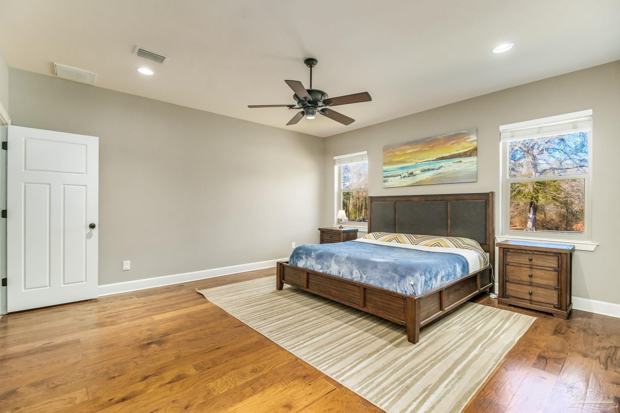 4940 Palmer Ridge Drive Milton, FL 32570 - Photo 21 of 53 a bedroom with a bed and a chandelier