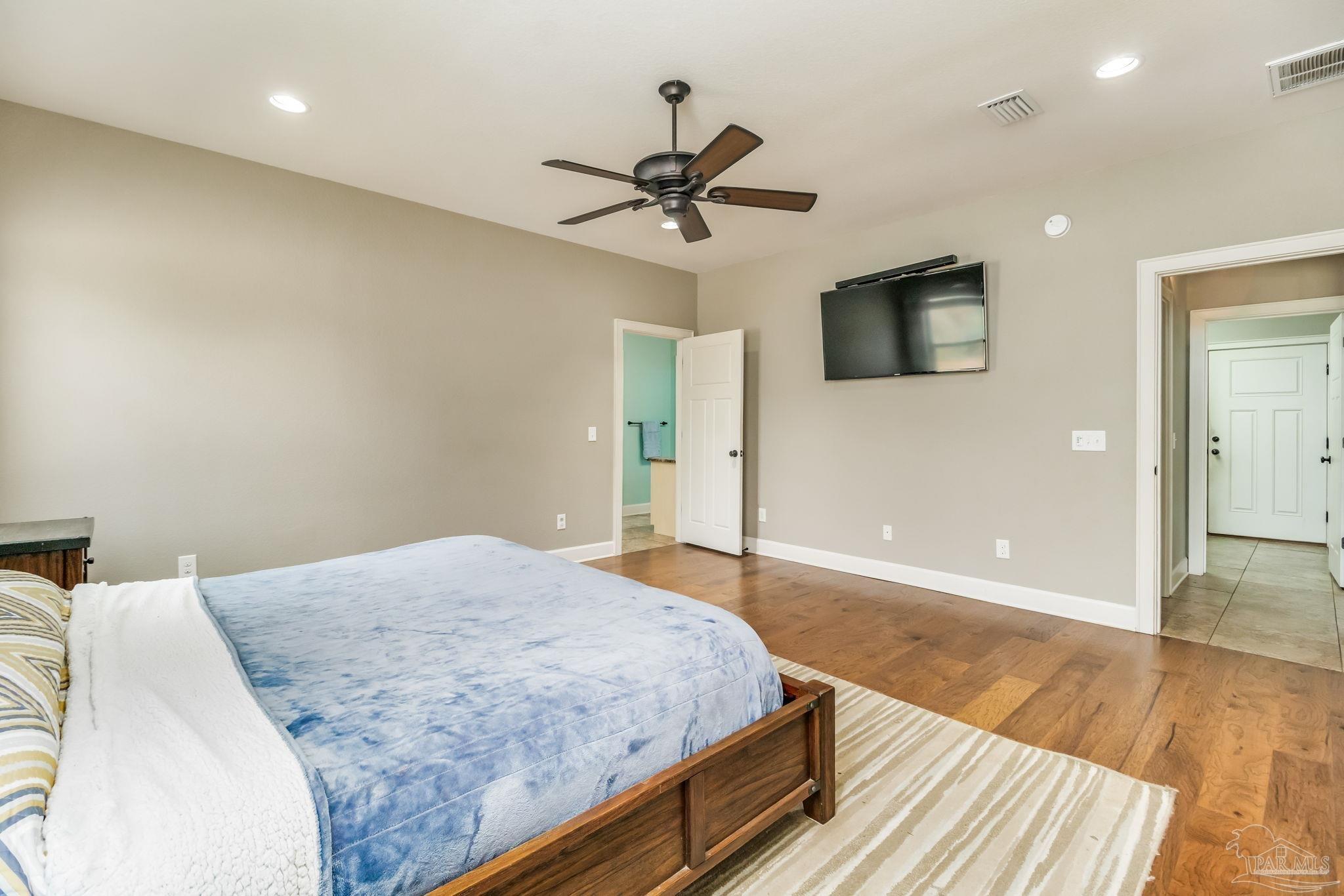 4940 Palmer Ridge Drive Milton, FL 32570 - Photo 22 of 53 a bedroom with a bed and a chandelier