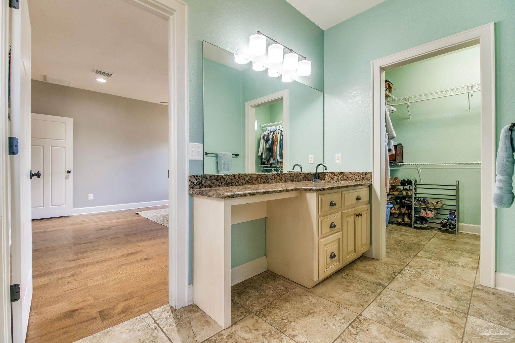 4940 Palmer Ridge Drive Milton, FL 32570 - Photo 23 of 53 a bathroom with a sink and a mirror