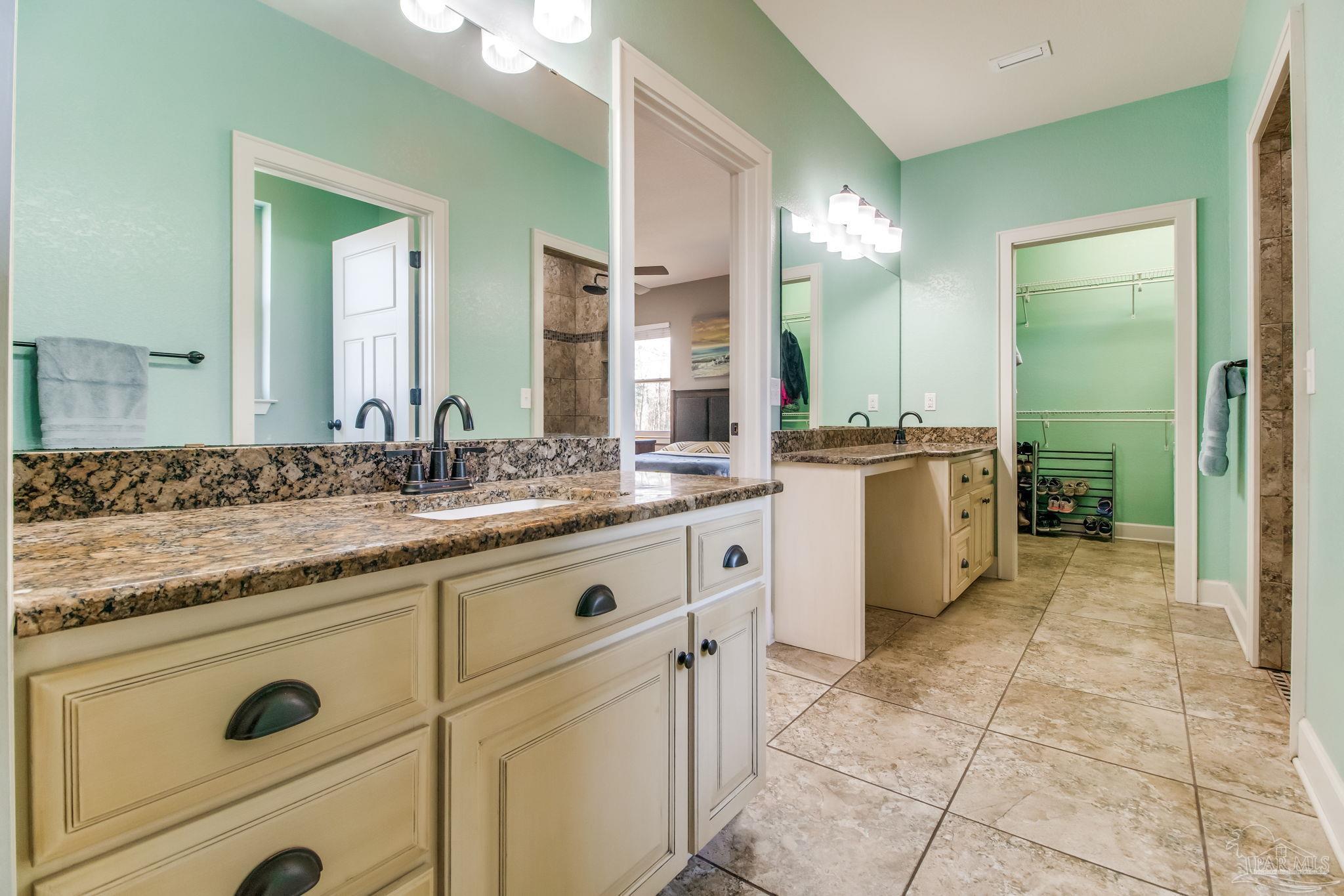 4940 Palmer Ridge Drive Milton, FL 32570 - Photo 24 of 53 a spacious bathroom with a granite countertop sink mirror and