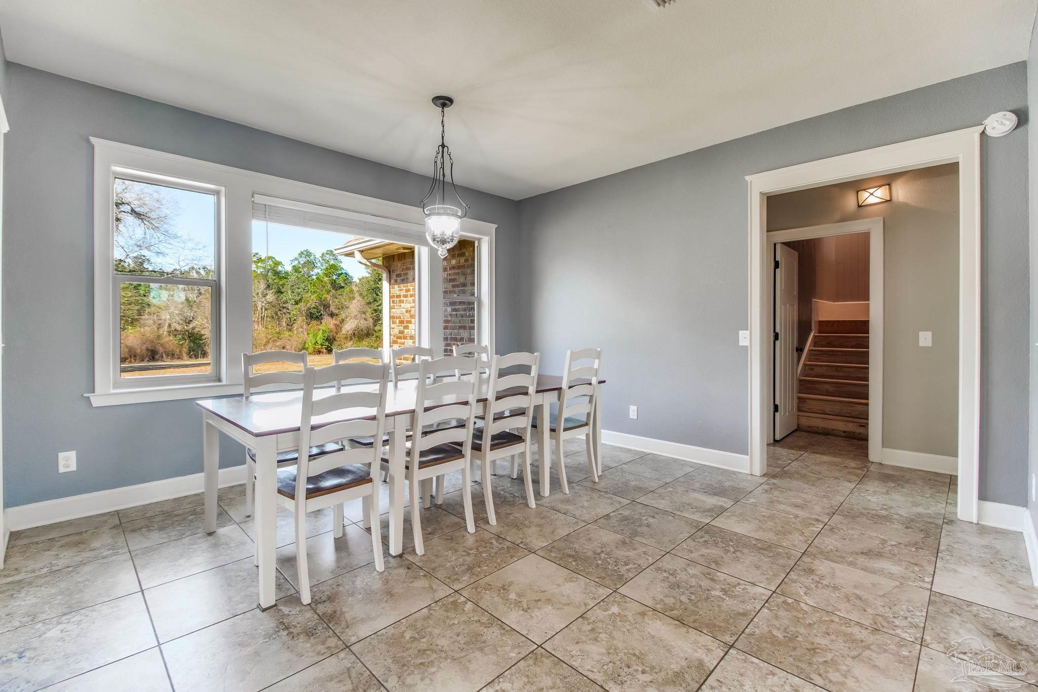 4940 Palmer Ridge Drive Milton, FL 32570 - Photo 25 of 53 a view of a dining room with furniture window and outside view