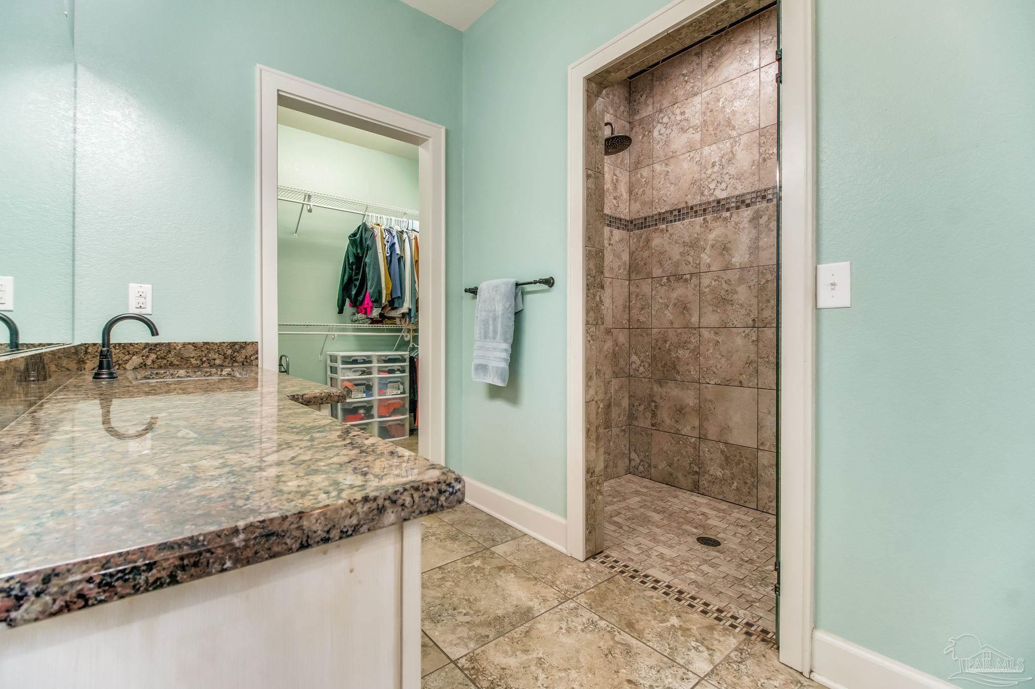 4940 Palmer Ridge Drive Milton, FL 32570 - Photo 28 of 53 a bathroom with a granite countertop sink and a mirror