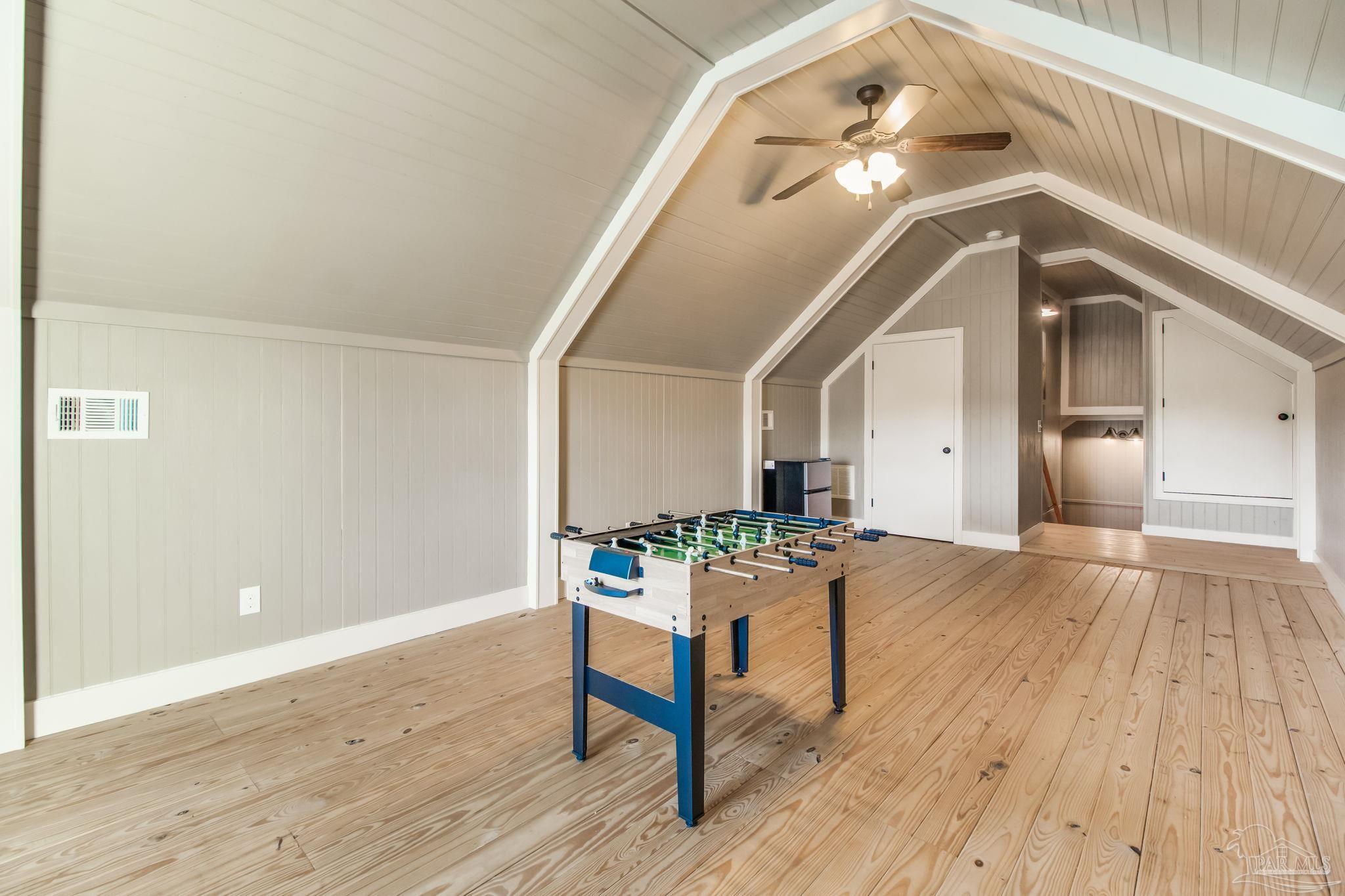 4940 Palmer Ridge Drive Milton, FL 32570 - Photo 29 of 53 a hallway with wooden floor table and chairs