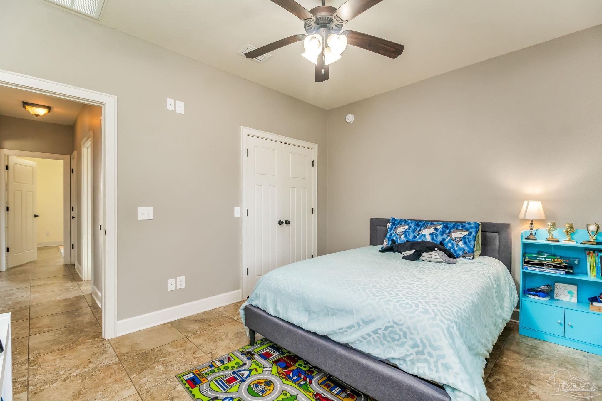 4940 Palmer Ridge Drive Milton, FL 32570 - Photo 32 of 53 a bedroom with a bed and a chandelier