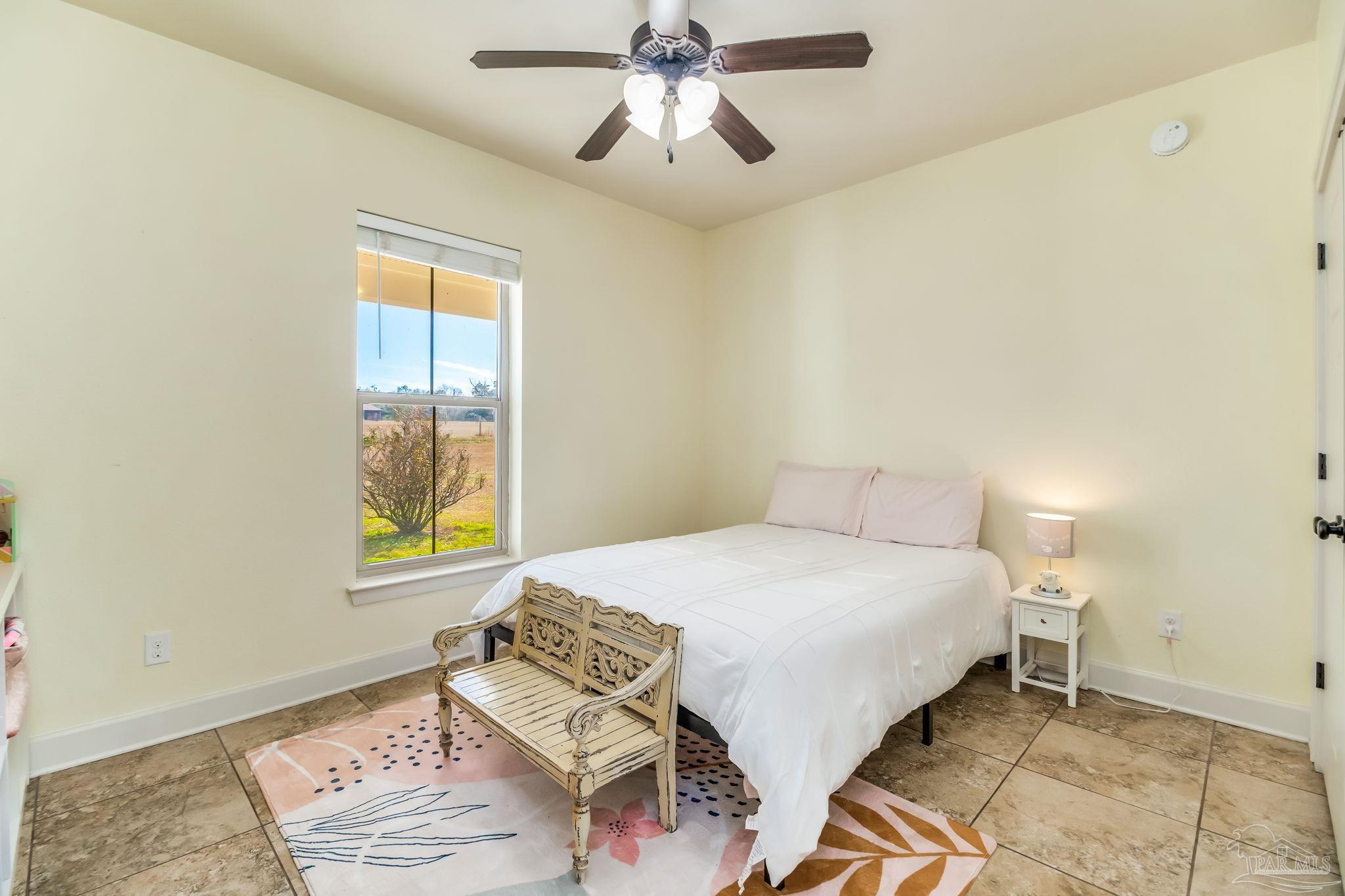 4940 Palmer Ridge Drive Milton, FL 32570 - Photo 37 of 53 a bedroom with a bed and a window