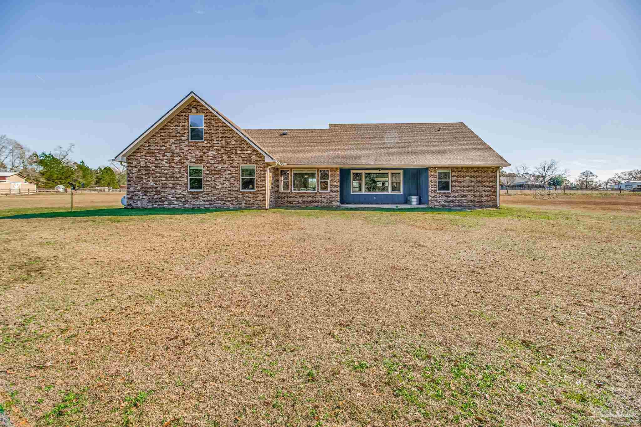 4940 Palmer Ridge Drive Milton, FL 32570 - Photo 40 of 53 a front view of a house with a yard