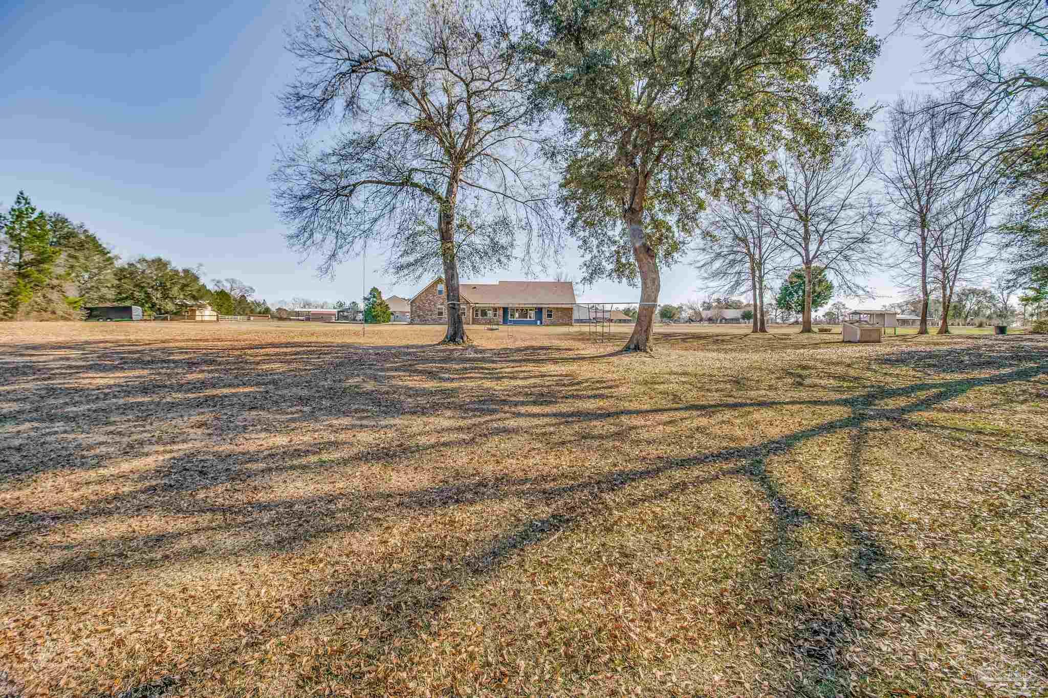 4940 Palmer Ridge Drive Milton, FL 32570 - Photo 44 of 53 a view of a yard with a trees