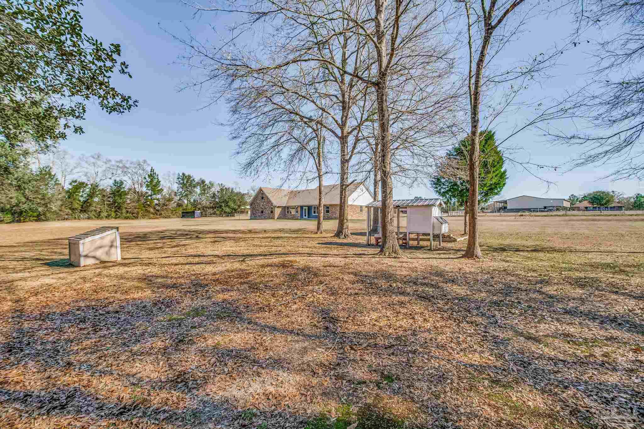 4940 Palmer Ridge Drive Milton, FL 32570 - Photo 46 of 53 a backyard of apartments with large trees