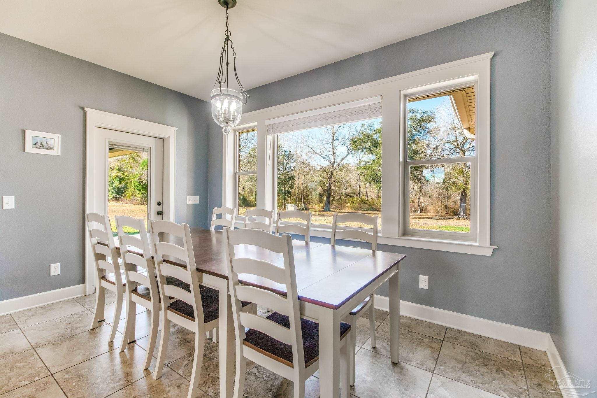 4940 Palmer Ridge Drive Milton, FL 32570 - Photo 6 of 53 a dining room with furniture and window