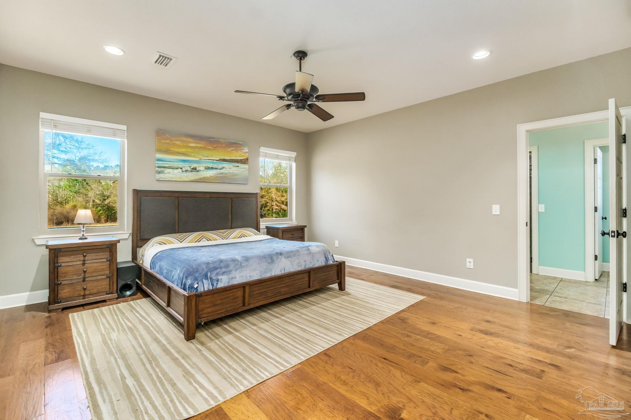 4940 Palmer Ridge Drive Milton, FL 32570 - Photo 7 of 53 a bedroom with a bed and a ceiling fan