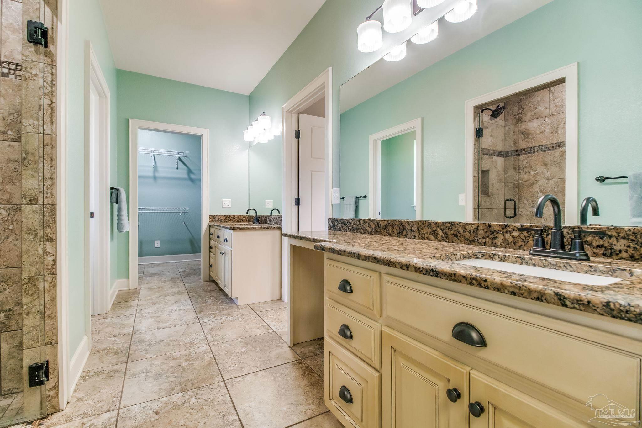 4940 Palmer Ridge Drive Milton, FL 32570 - Photo 8 of 53 a bathroom with a granite countertop sink mirror and a
