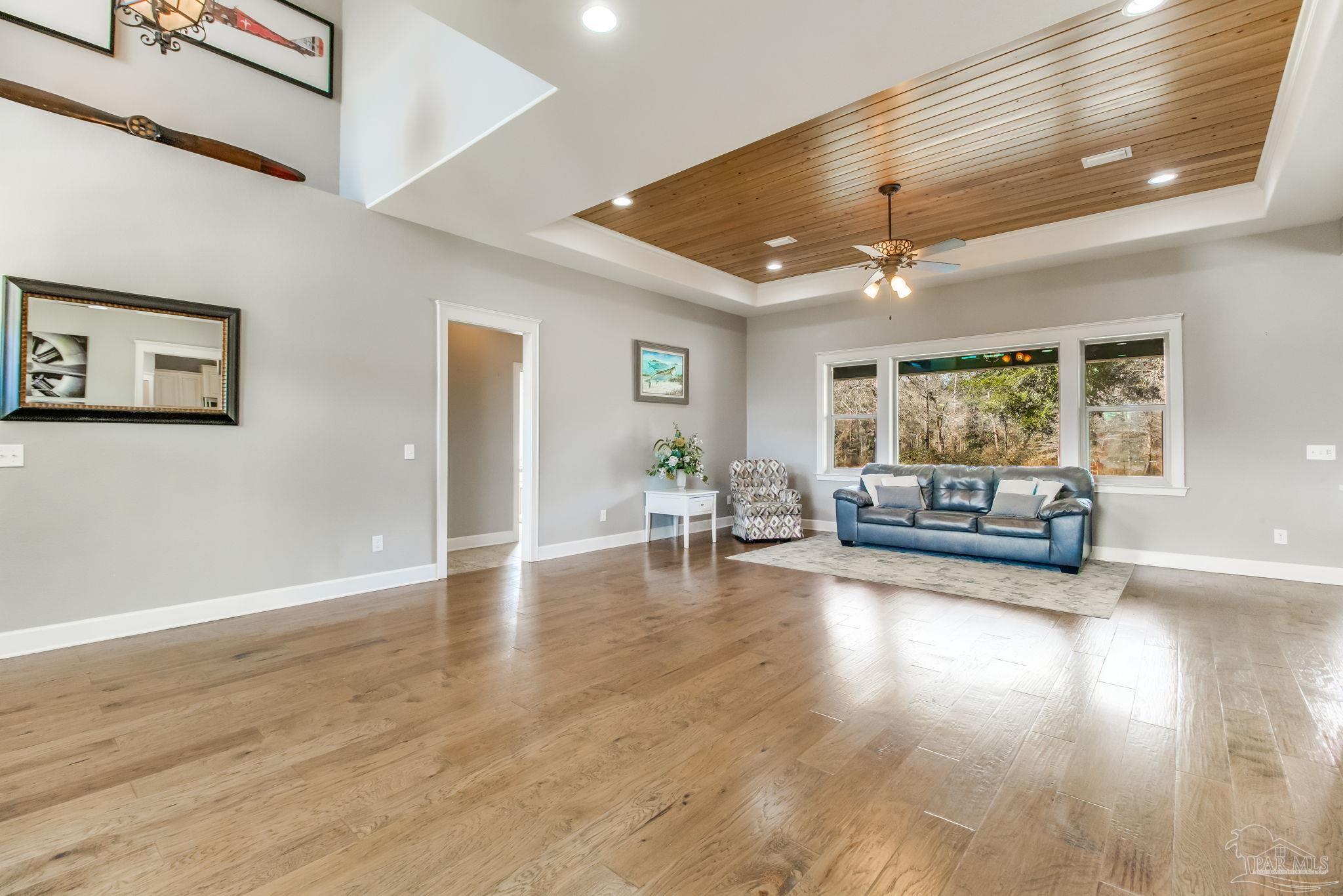 4940 Palmer Ridge Drive Milton, FL 32570 - Photo 9 of 53 a living room with furniture and a large window