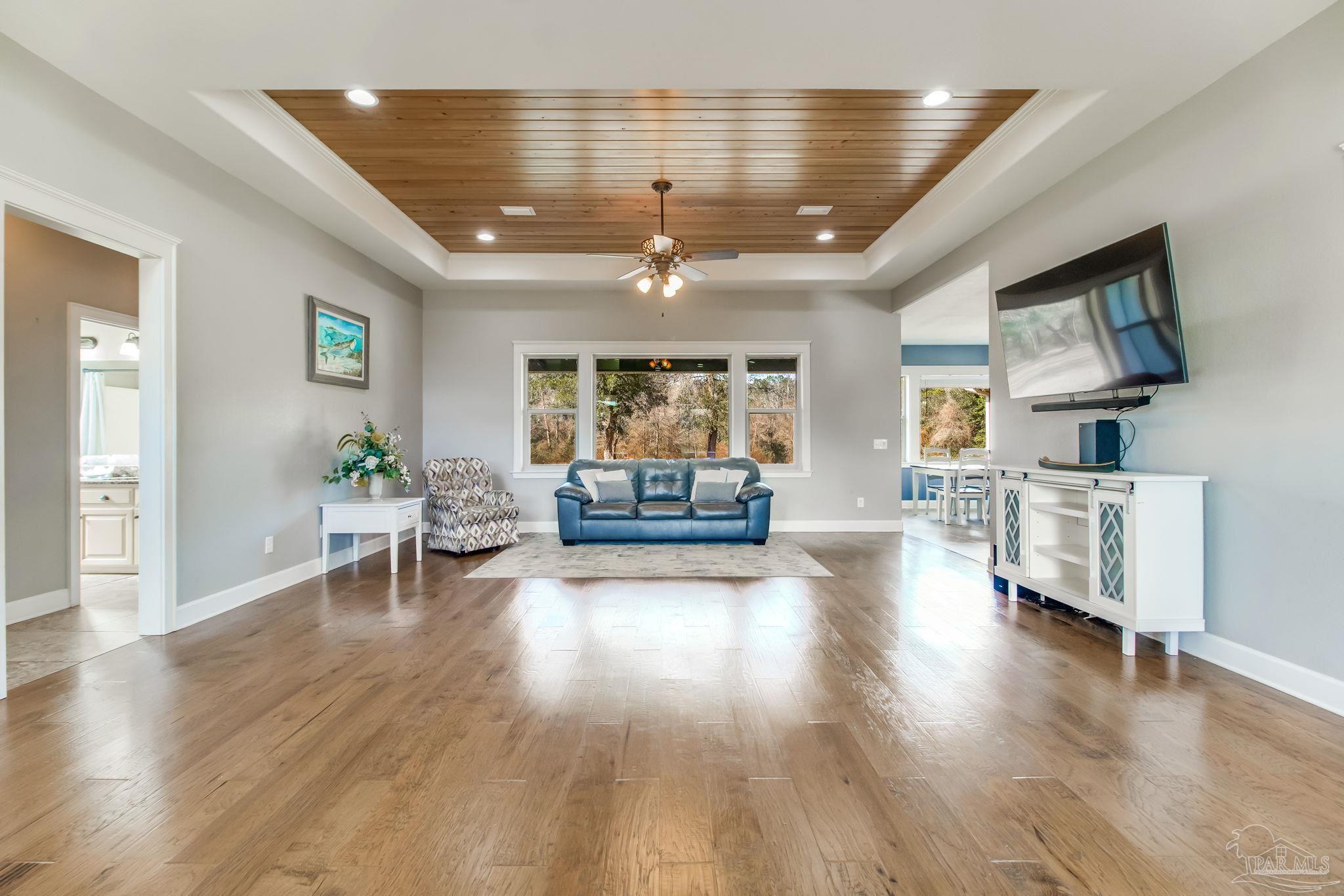 4940 Palmer Ridge Drive Milton, FL 32570 - Photo 10 of 53 a living room with furniture and a wooden floor