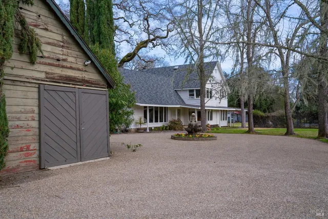 a view of a house with backyard and sitting area