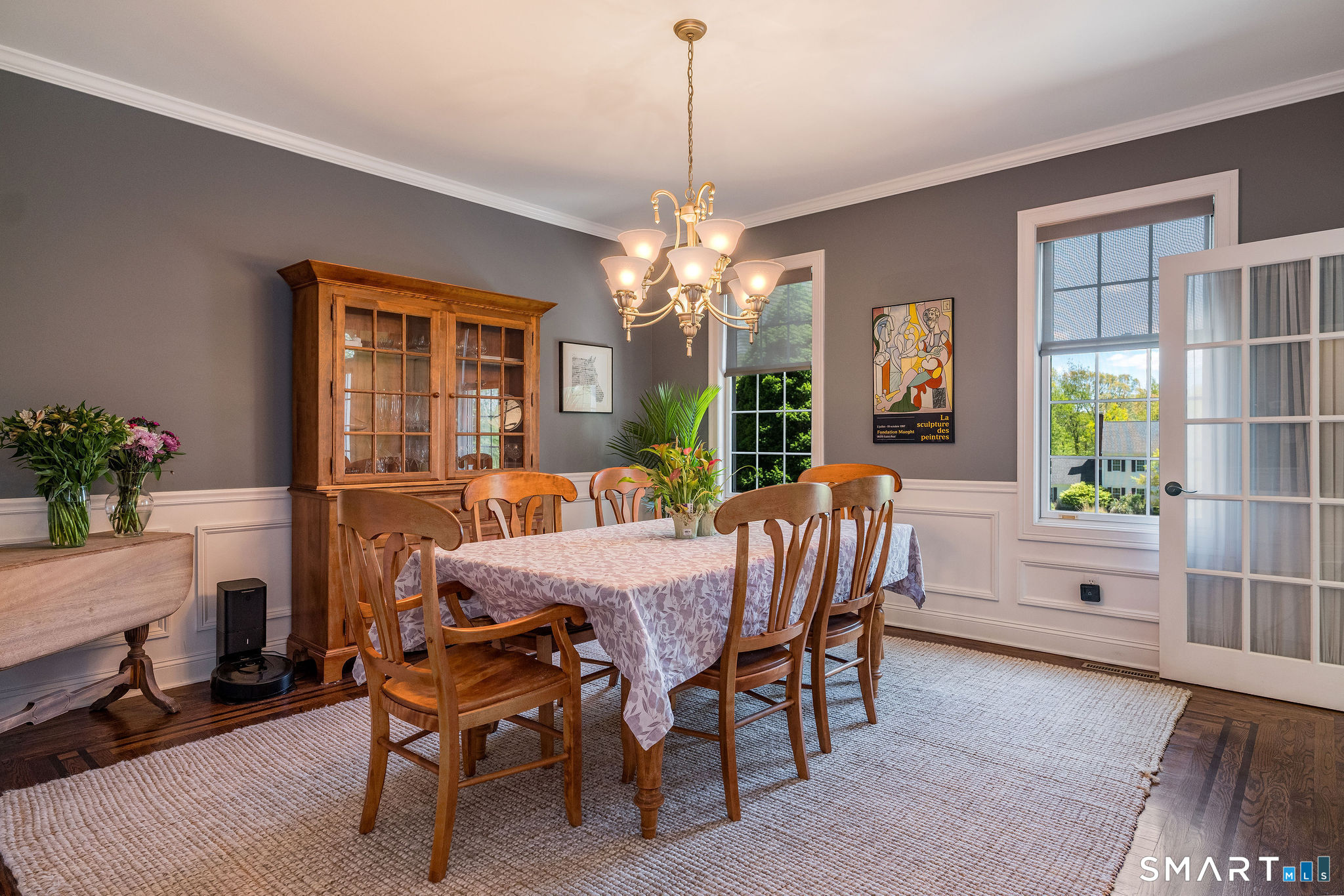 170 Devonshire Lane Madison, CT 06443 - Photo 16 of 39 a dining room with furniture potted plants and wooden floor