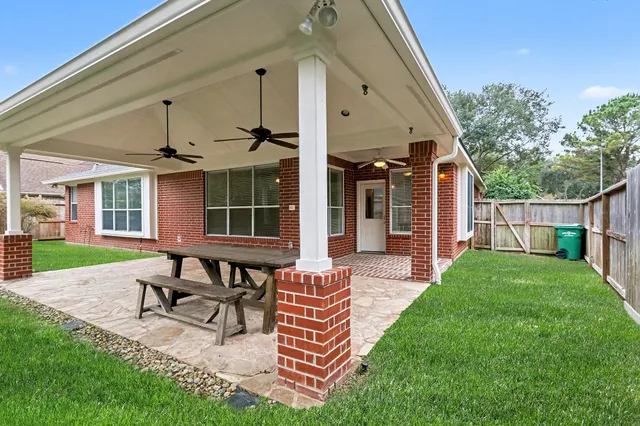 a view of a patio with a table and chairs