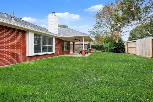 a backyard of a house with table and chairs