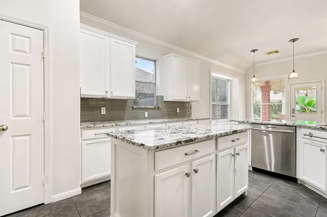 a kitchen with stainless steel appliances granite countertop a stove a sink and a microwave
