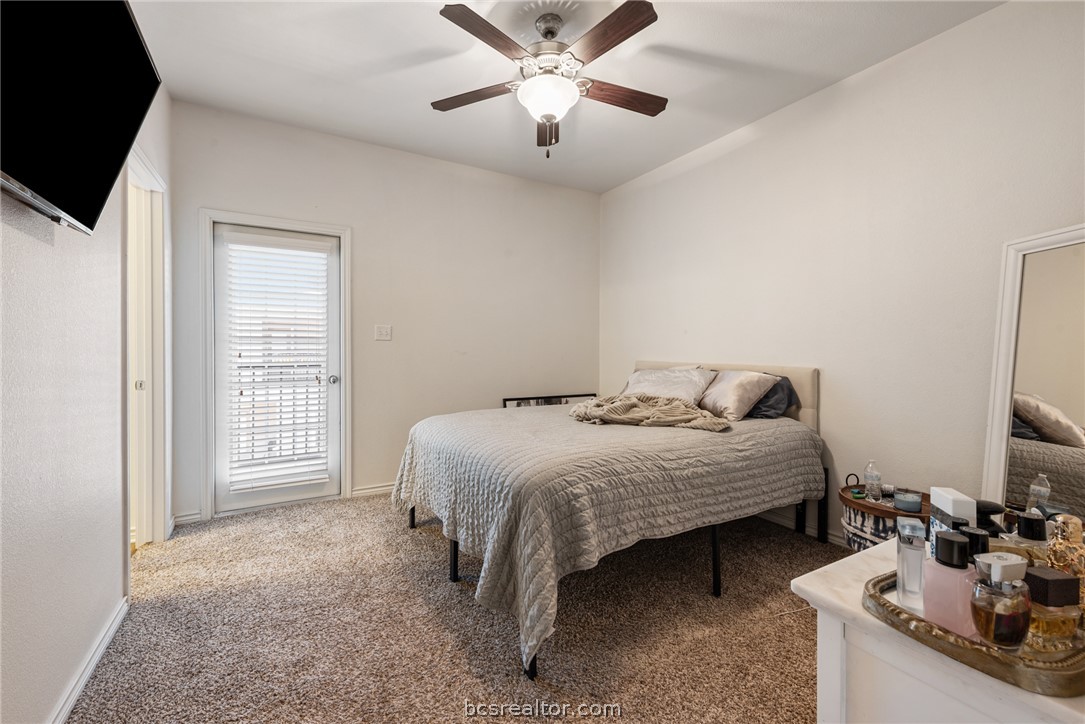 403 Kate Lane College Station, TX 77845 - Photo 13 of 23 a bedroom with a bed and a chandelier