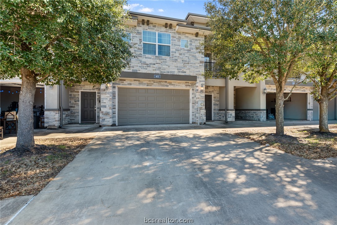 403 Kate Lane College Station, TX 77845 - Photo 23 of 23 a front view of a house with a yard and garage