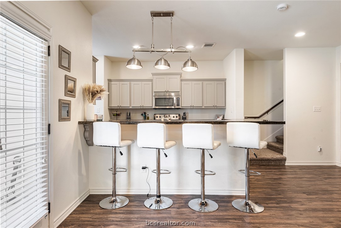 403 Kate Lane College Station, TX 77845 - Photo 8 of 23 a kitchen with stainless steel appliances granite countertop a refrigerator and stove top oven