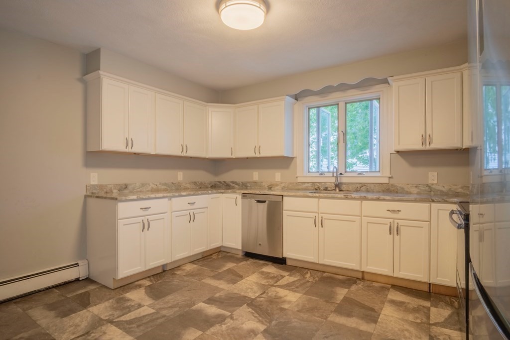 10 Maple Avenue Danvers, MA 01923 - Photo 14 of 41 a kitchen with granite countertop cabinets sink and white appliances