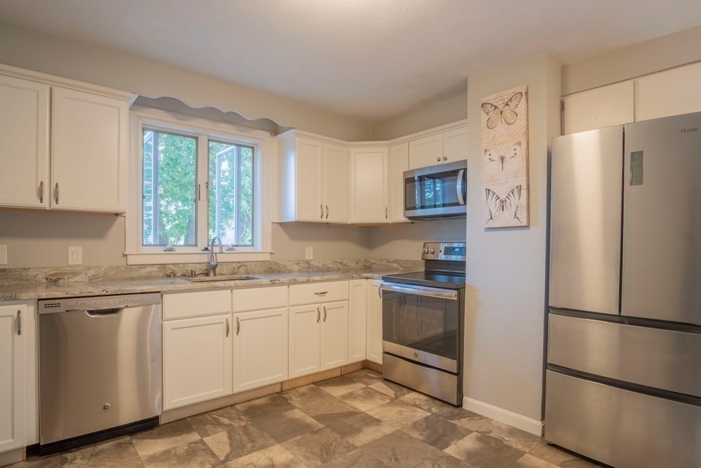 10 Maple Avenue Danvers, MA 01923 - Photo 16 of 41 a kitchen with stainless steel appliances granite countertop a refrigerator sink and stove