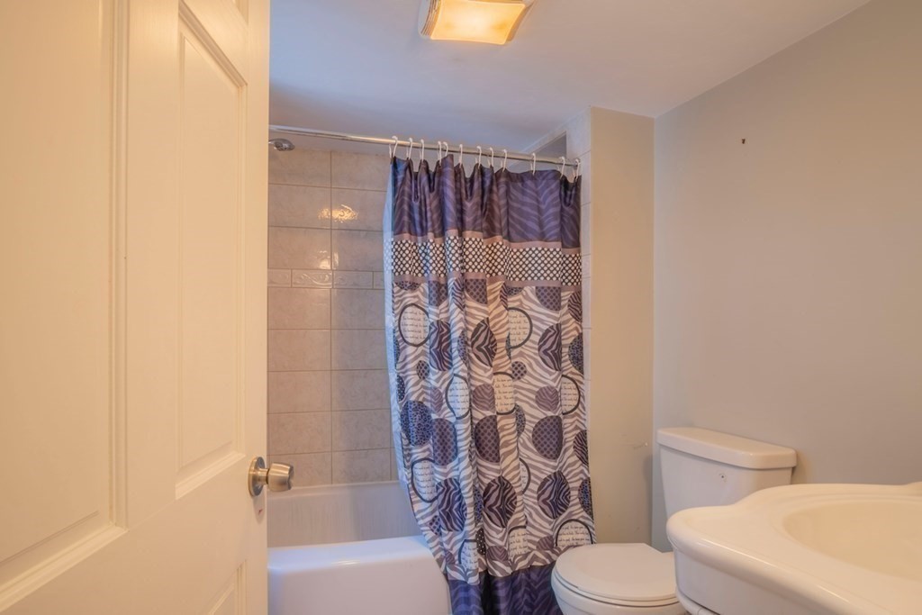 10 Maple Avenue Danvers, MA 01923 - Photo 25 of 41 a white toilet sitting next to a bathroom sink