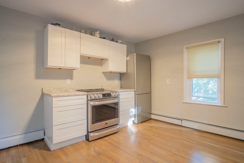 10 Maple Avenue Danvers, MA 01923 - Photo 29 of 41 a kitchen with a stove top oven and cabinets