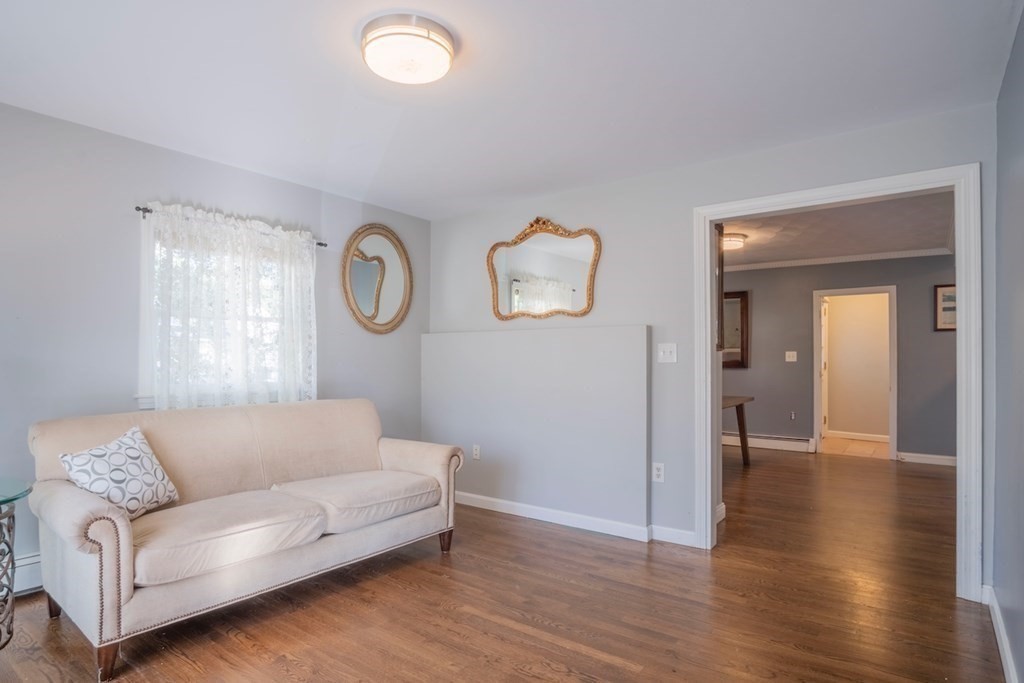 10 Maple Avenue Danvers, MA 01923 - Photo 4 of 41 a living room with couches and a large mirror with wooden floor