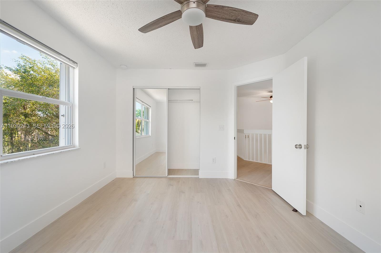22300 Sands Point Drive Boca Raton, FL 33433 - Photo 11 of 17 a view of an empty room with window and wooden floor